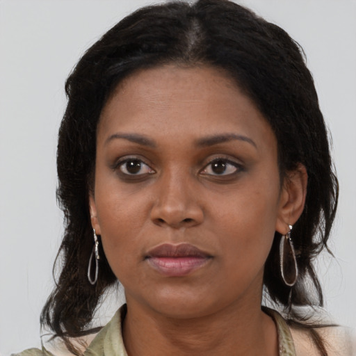 Neutral black young-adult female with medium  brown hair and brown eyes