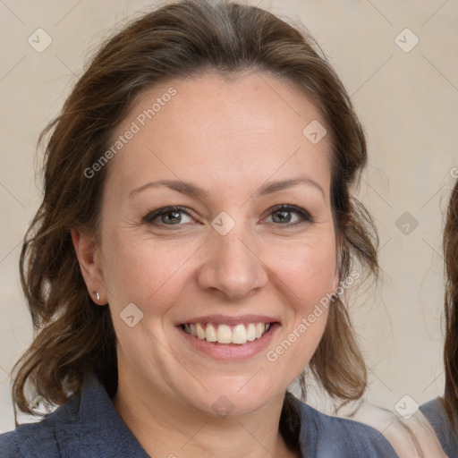 Joyful white adult female with medium  brown hair and blue eyes