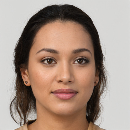 Joyful latino young-adult female with medium  brown hair and brown eyes