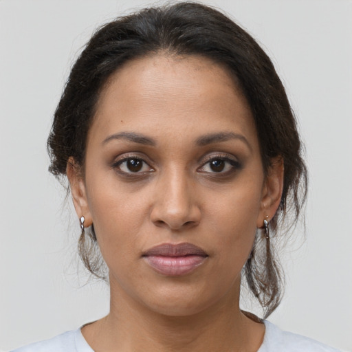 Joyful black young-adult female with medium  brown hair and brown eyes