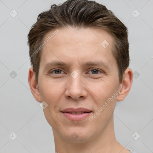 Joyful white young-adult male with short  brown hair and grey eyes