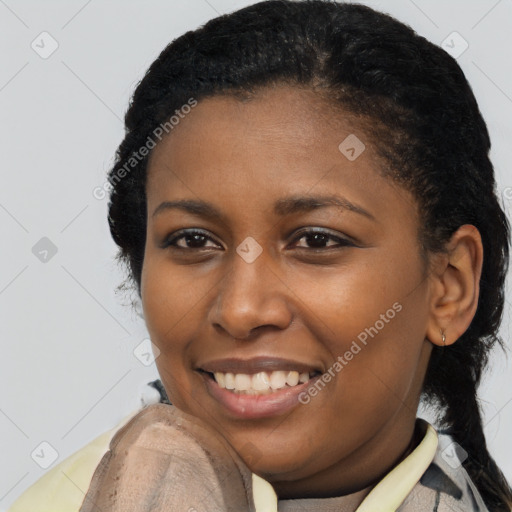 Joyful black young-adult female with short  brown hair and brown eyes