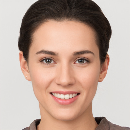 Joyful white young-adult female with short  brown hair and brown eyes