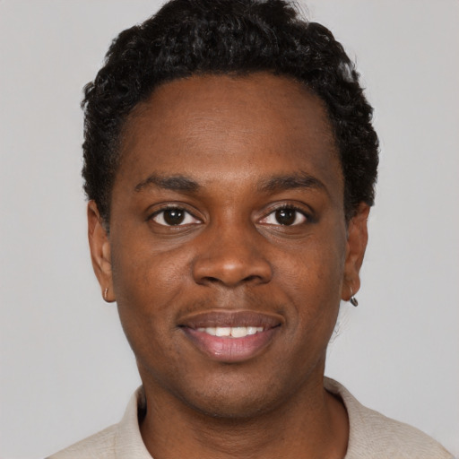 Joyful black young-adult male with short  black hair and brown eyes