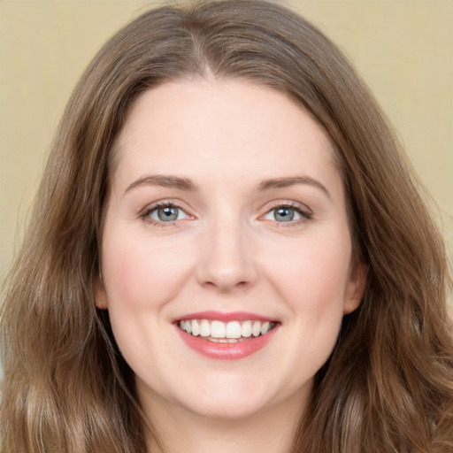 Joyful white young-adult female with long  brown hair and green eyes