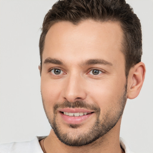 Joyful white young-adult male with short  brown hair and brown eyes