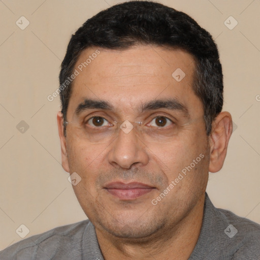 Joyful white adult male with short  black hair and brown eyes