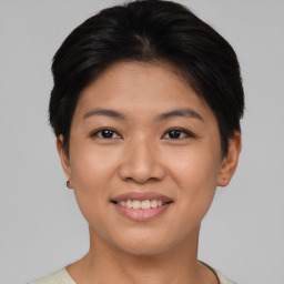 Joyful asian young-adult female with short  brown hair and brown eyes