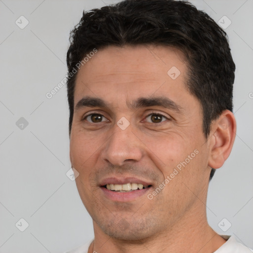 Joyful white young-adult male with short  black hair and brown eyes