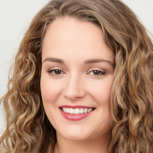 Joyful white young-adult female with long  brown hair and green eyes