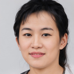 Joyful asian young-adult female with medium  black hair and brown eyes