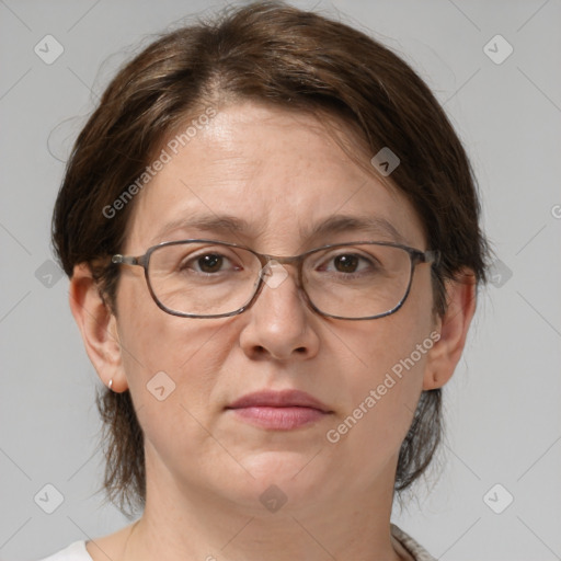 Joyful white adult female with medium  brown hair and grey eyes