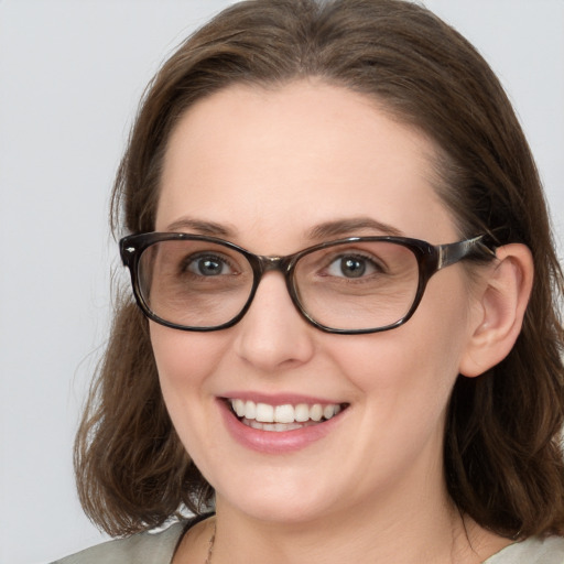 Joyful white young-adult female with medium  brown hair and blue eyes