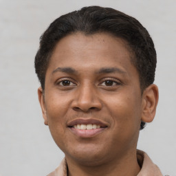 Joyful latino young-adult male with short  brown hair and brown eyes