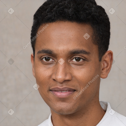 Joyful black young-adult male with short  black hair and brown eyes