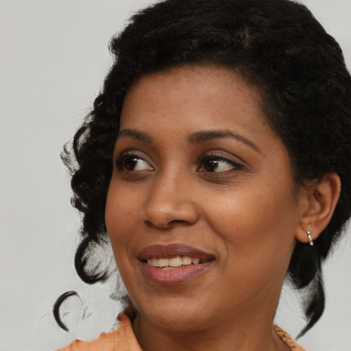 Joyful black young-adult female with medium  black hair and brown eyes