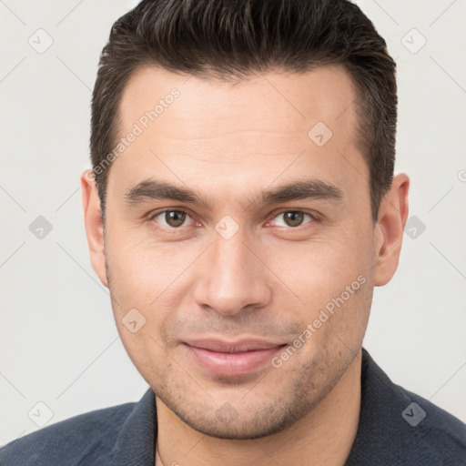 Joyful white young-adult male with short  brown hair and brown eyes