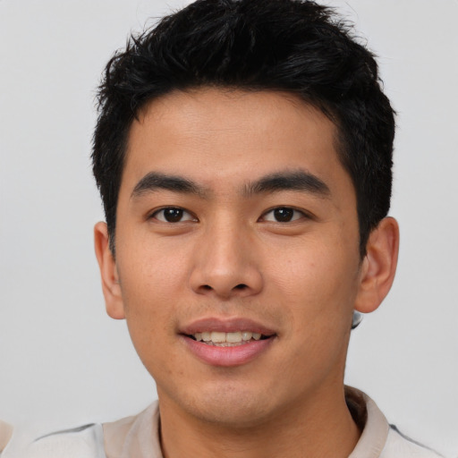 Joyful asian young-adult male with short  black hair and brown eyes