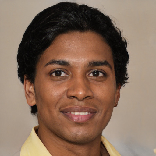 Joyful latino young-adult male with short  brown hair and brown eyes