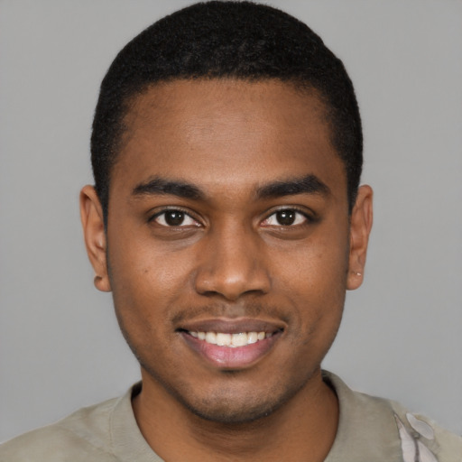 Joyful black young-adult male with short  black hair and brown eyes