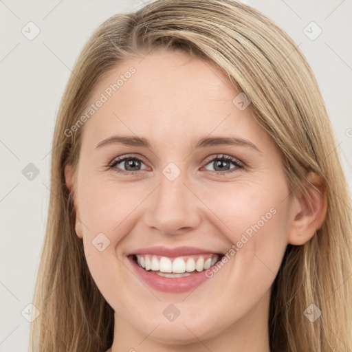 Joyful white young-adult female with long  brown hair and blue eyes