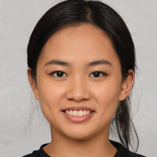 Joyful asian young-adult female with medium  black hair and brown eyes