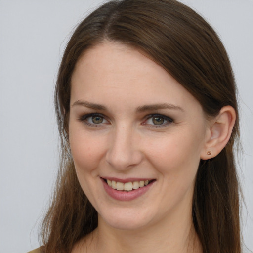 Joyful white young-adult female with long  brown hair and grey eyes