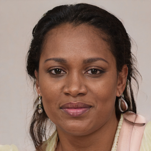 Joyful latino adult female with medium  brown hair and brown eyes