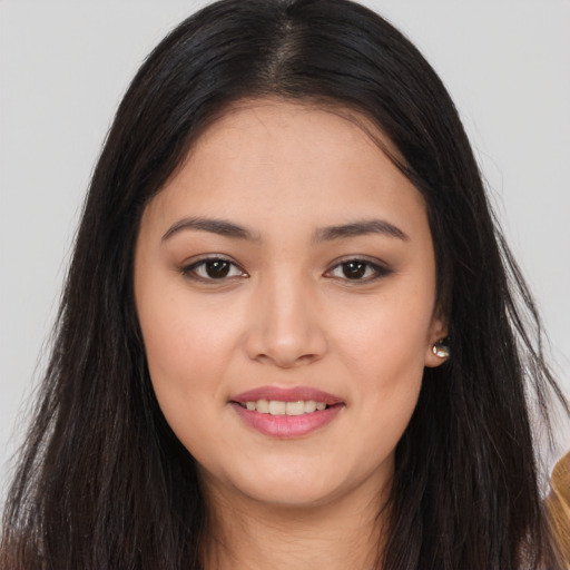 Joyful asian young-adult female with long  brown hair and brown eyes