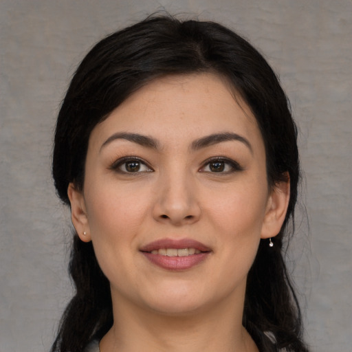 Joyful asian young-adult female with long  black hair and brown eyes