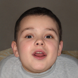 Joyful white child male with short  brown hair and brown eyes