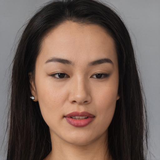 Joyful asian young-adult female with long  brown hair and brown eyes