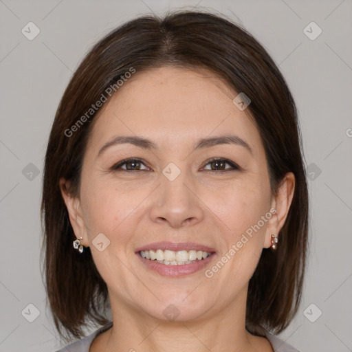 Joyful white adult female with medium  brown hair and brown eyes