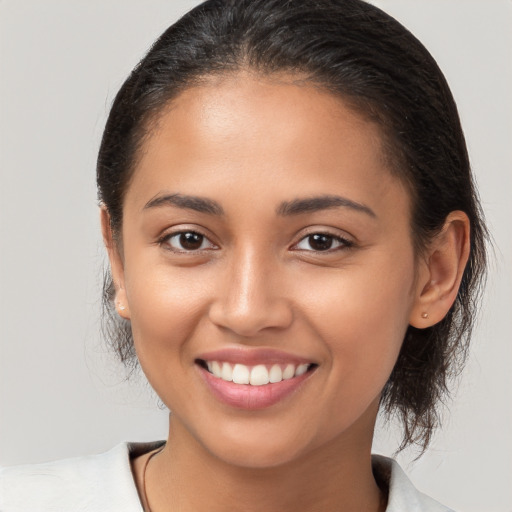 Joyful latino young-adult female with medium  brown hair and brown eyes