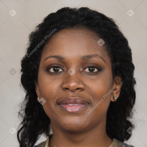 Joyful black young-adult female with long  black hair and brown eyes