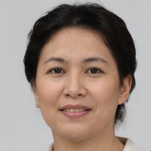 Joyful white adult female with medium  brown hair and brown eyes