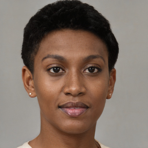 Joyful black young-adult female with short  black hair and brown eyes