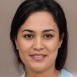 Joyful latino young-adult female with medium  brown hair and brown eyes