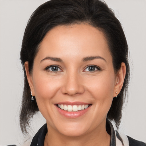 Joyful white young-adult female with medium  brown hair and brown eyes