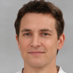 Joyful white adult male with short  brown hair and brown eyes