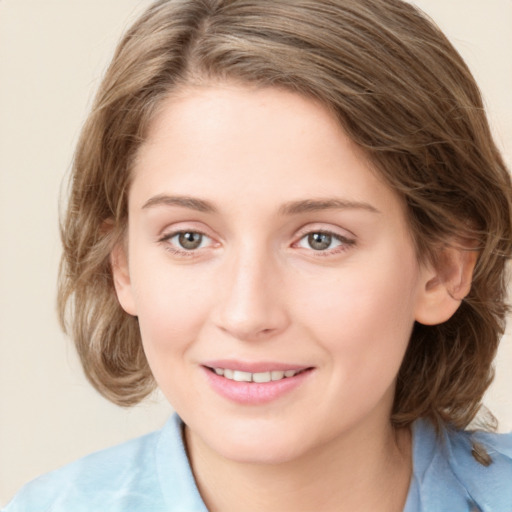 Joyful white young-adult female with medium  brown hair and green eyes