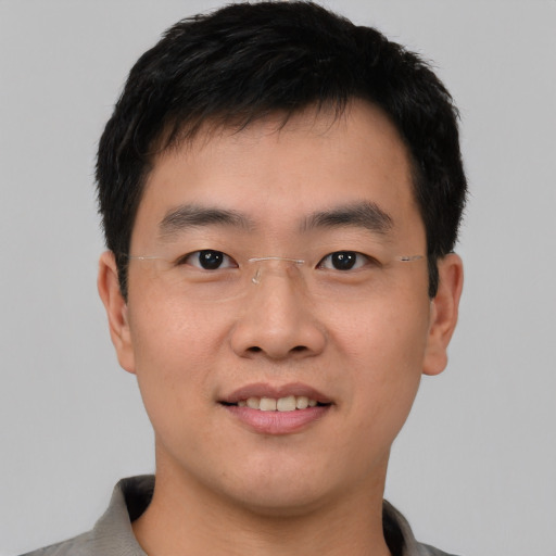 Joyful asian young-adult male with short  black hair and brown eyes