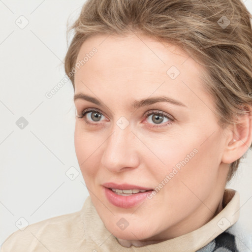 Joyful white young-adult female with medium  brown hair and blue eyes