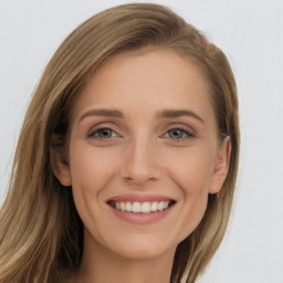 Joyful white young-adult female with long  brown hair and grey eyes