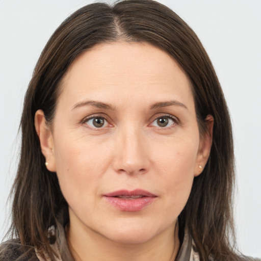 Joyful white adult female with medium  brown hair and brown eyes