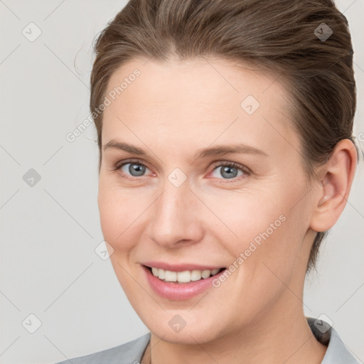 Joyful white young-adult female with short  brown hair and grey eyes