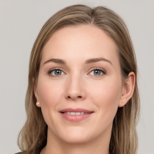 Joyful white young-adult female with long  brown hair and grey eyes