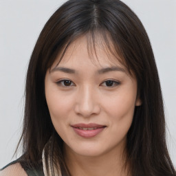 Joyful asian young-adult female with long  brown hair and brown eyes