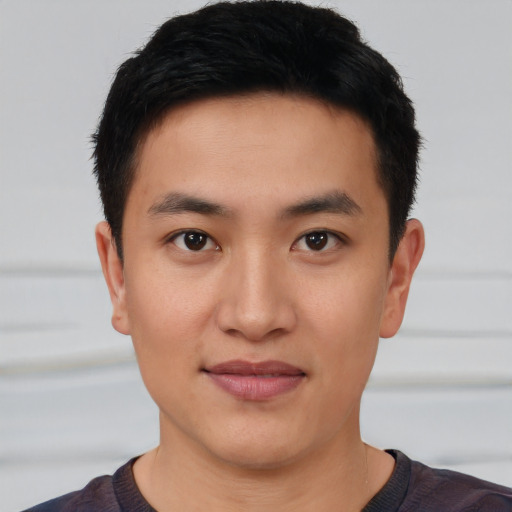 Joyful asian young-adult male with short  black hair and brown eyes