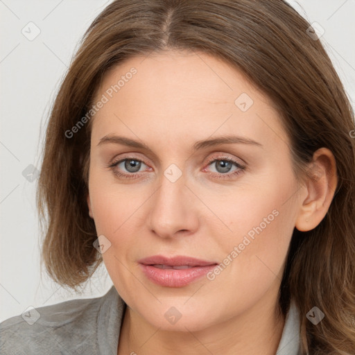 Joyful white young-adult female with long  brown hair and blue eyes